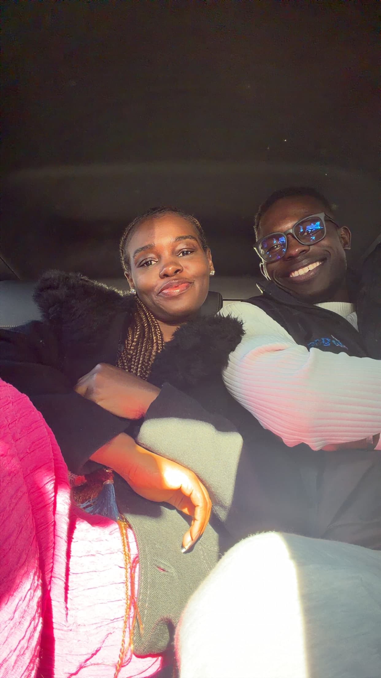 Ayo and Ola taking a nighttime selfie inside the car