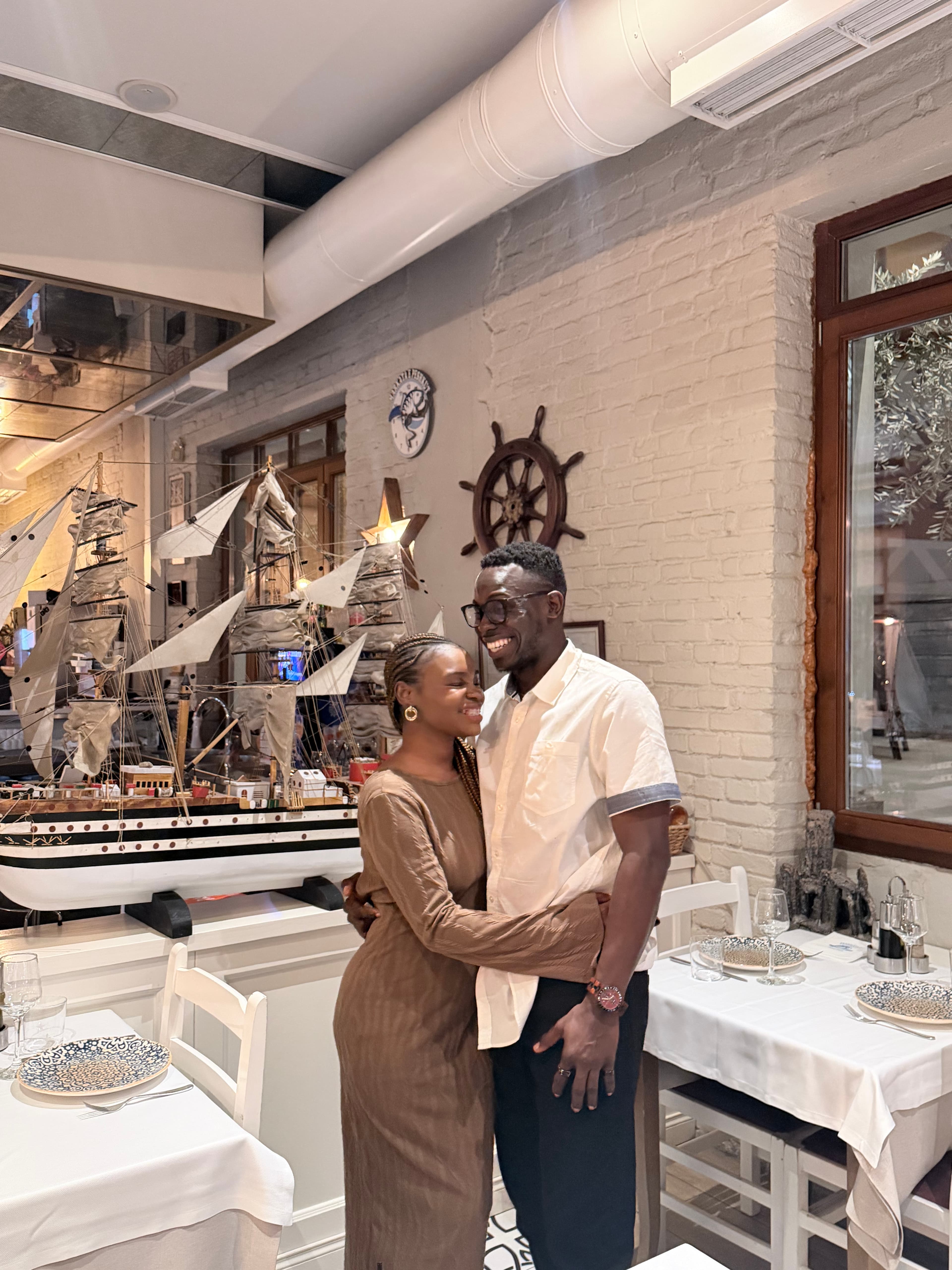 Ayo and Ola embracing during a dinner date