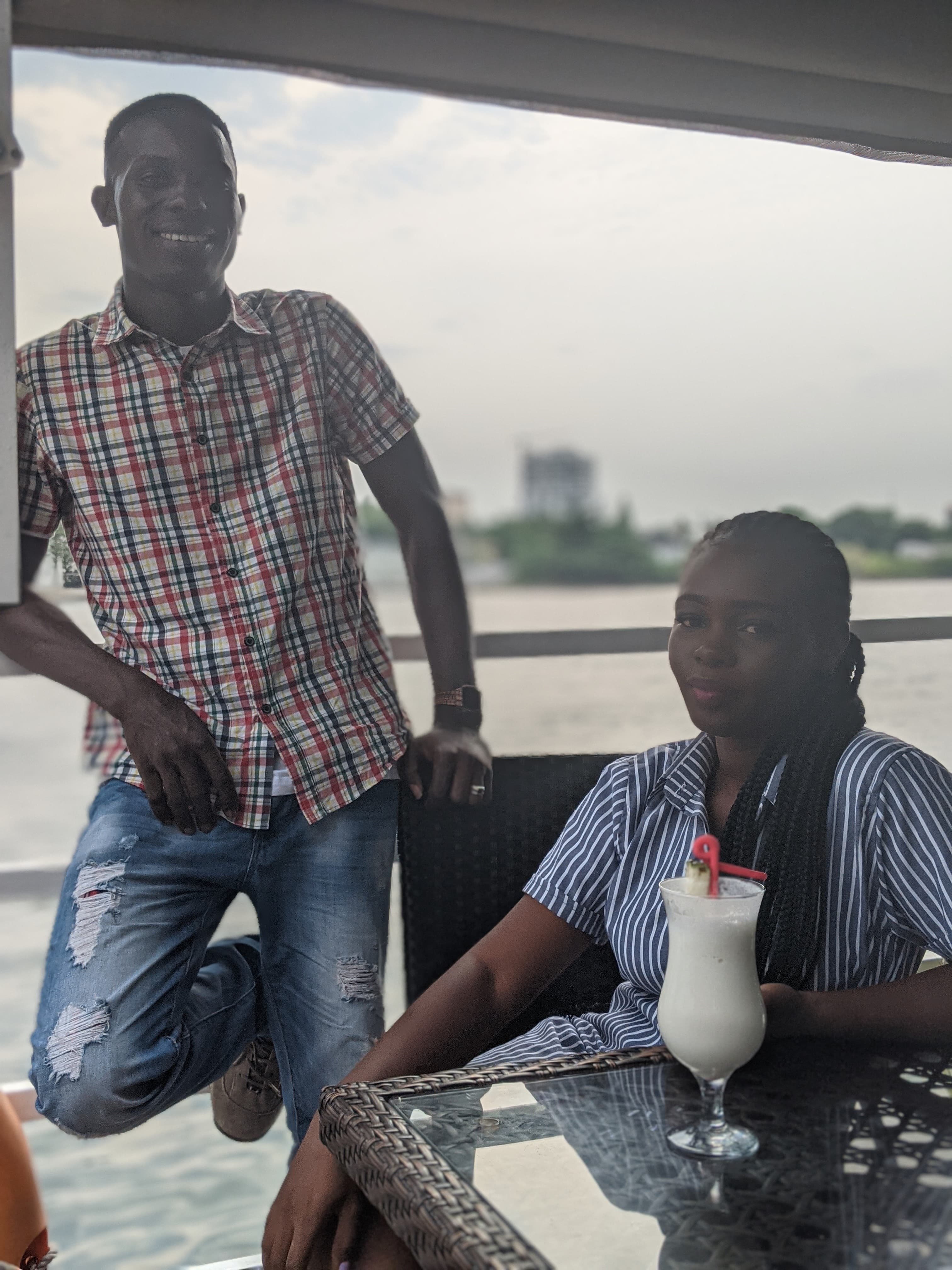 Ayo and Ola enjoying drinks together at an outdoor café