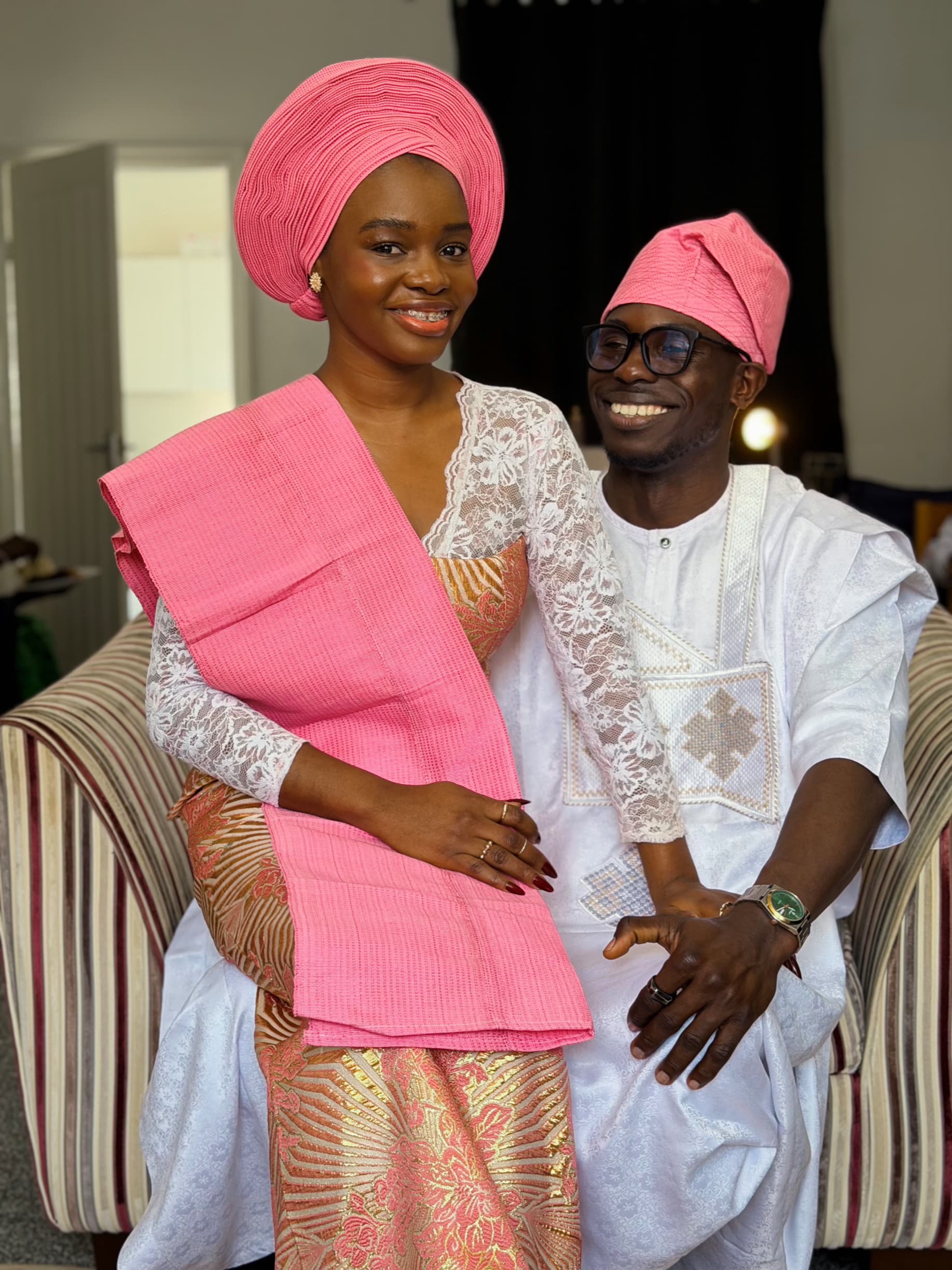 Ayo and Ola smiling together in traditional attire